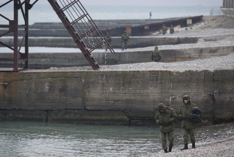 Russian servicemen stand at the shores of the Black Sea near the crash site of a Russian military Tu-154 plane, in the Sochi suburb of Khosta, Russia December 25, 2016. REUTERS/Maxim Shemetov