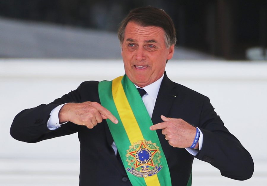 Brazil's new President Jair Bolsonaro gestures after receiving the presidential sash from outgoing President Michel Temer at the Planalto Palace, in Brasilia, Brazil January 1, 2019. REUTERS/Sergio Moraes
