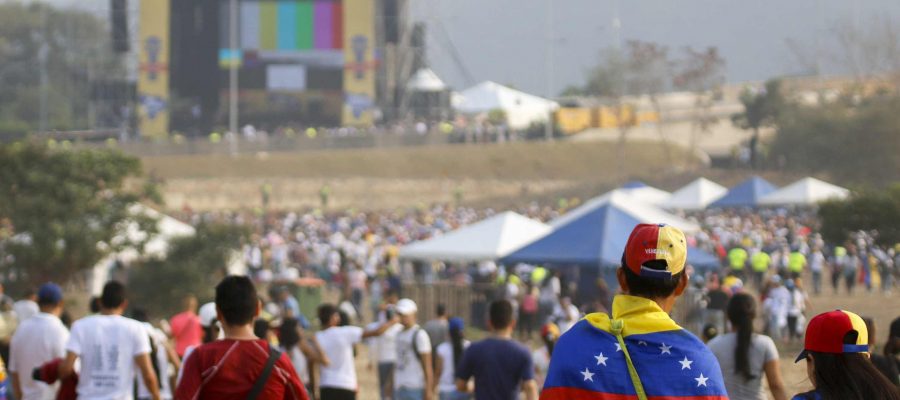 People wait for the start of "Venezuela Aid Live" concert, organized by British billionaire Richard Branson to raise money for the Venezuelan relief effort at Tienditas International Bridge in Cucuta, Colombia, on February 22, 2019 - The concert was organized by British billionaire Richard Branson to raise money for the Venezuelan relief effort. Venezuela's political tug-of-war morphs into a battle of the bands on Friday, with dueling government and opposition pop concerts ahead of a weekend showdown over the entry of badly needed food and medical aid. (Photo by SCHNEYDER MENDOZA / AFP)